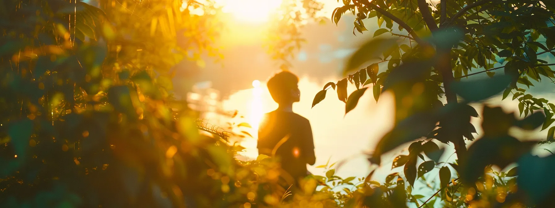 a serene nature scene bathed in soft pastel hues, featuring a silhouette of a person standing peacefully amidst lush greenery, symbolizing hope and healing in the journey of addiction recovery.